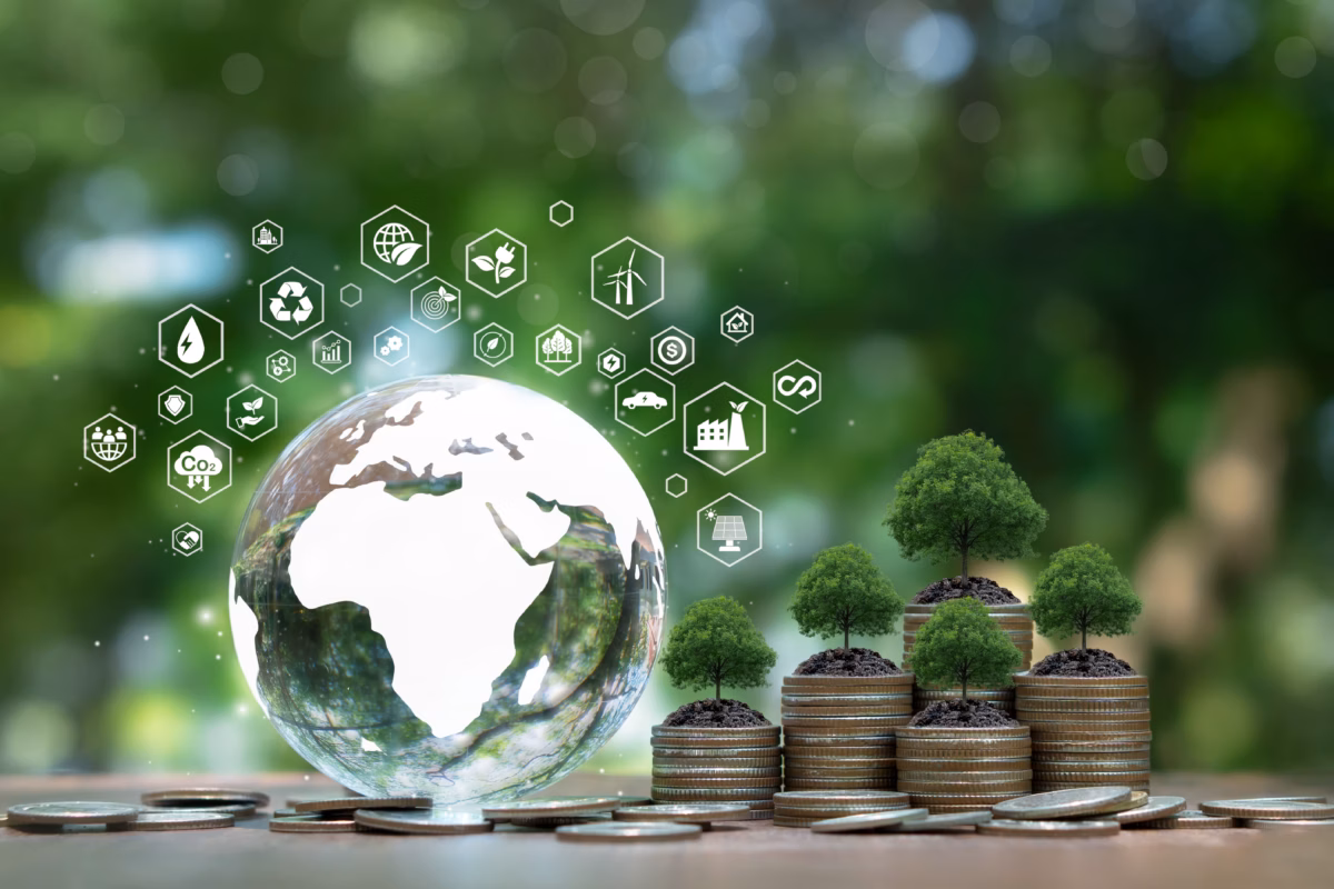 Globe and trees growing on coins symbolizing renewable energy grants and sustainable business growth in Europe